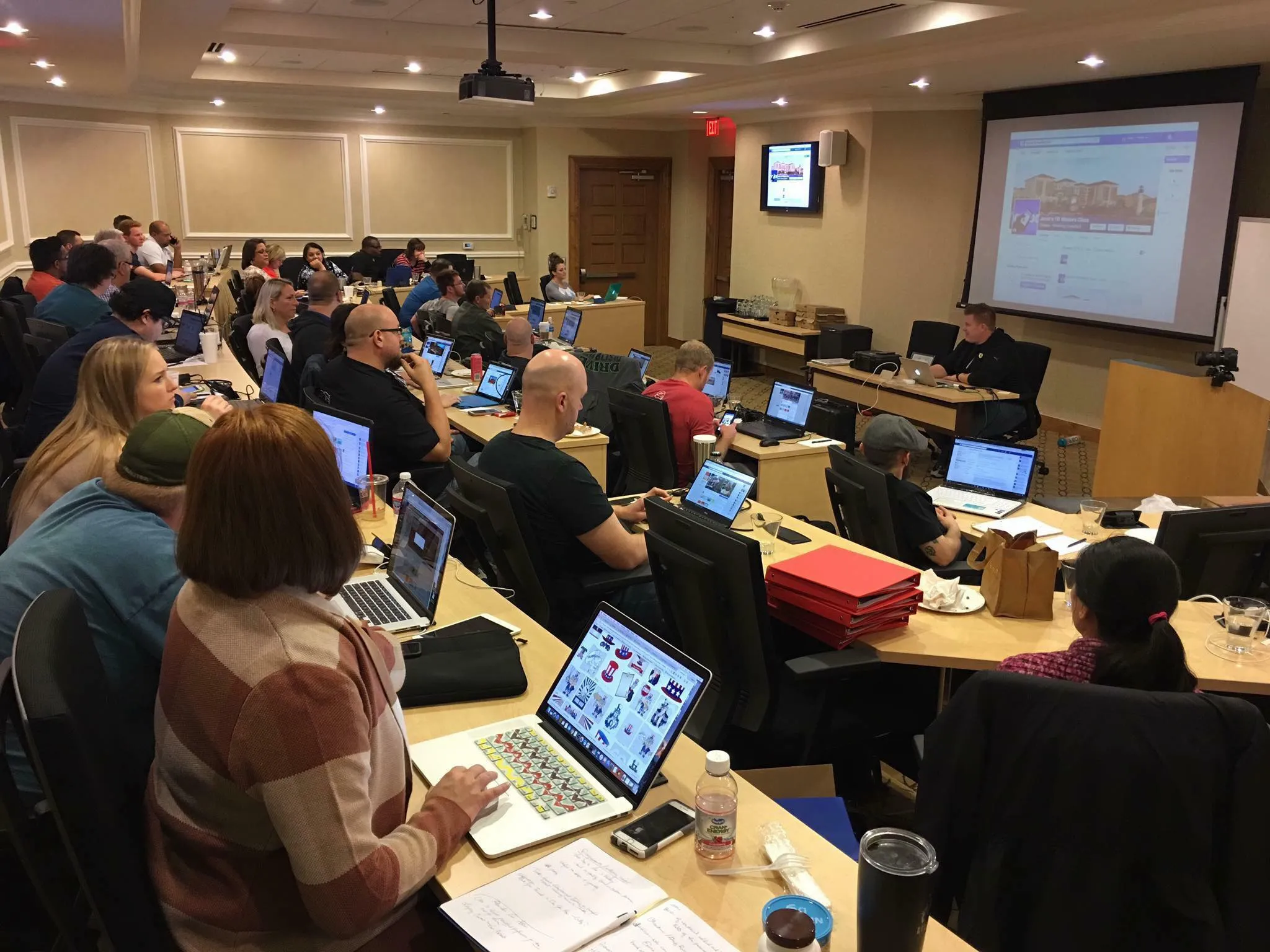 Attendees at laptops around conference tables during a Masters Class session